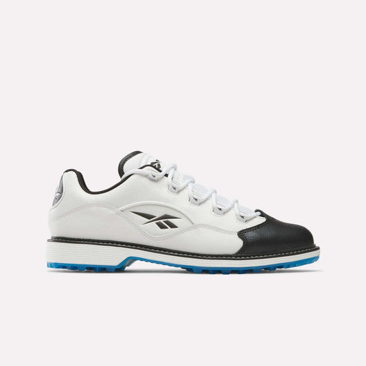 The Reebok Question Golf Shoes feature a white and black low-top design with blue sole accents, crafted from full grain leather and adorned with the Reebok logo, highlighting premium style against a plain light background.