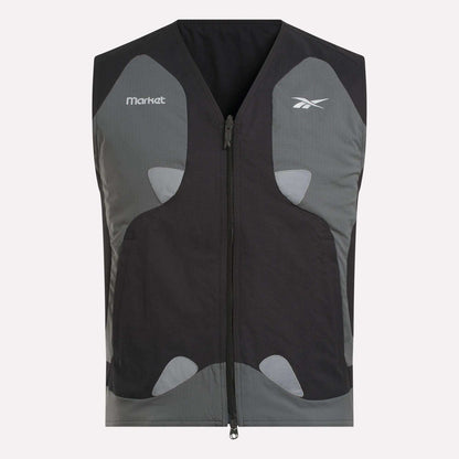 The Reebok x MARKET Reversible Vest is a black and gray streetwear sleeveless vest with a front zipper, chest logos from Reebok and Market, and light gray accent patches on the front.