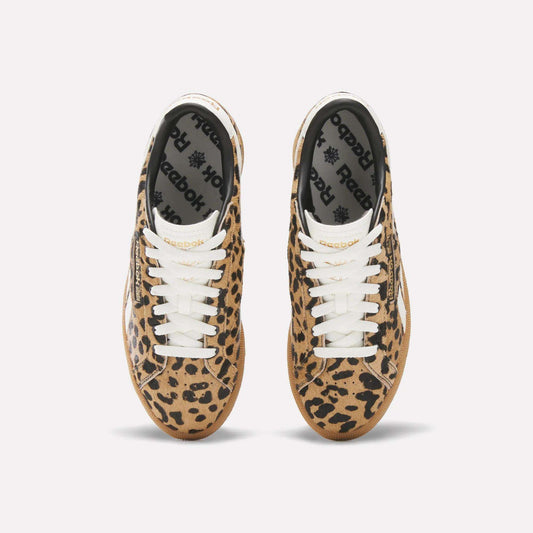 A pair of Reebok Women's Club C Grounds UK Shoes with a tan and black leopard print, white laces, and black Reebok insoles is seen from above on a plain white background.