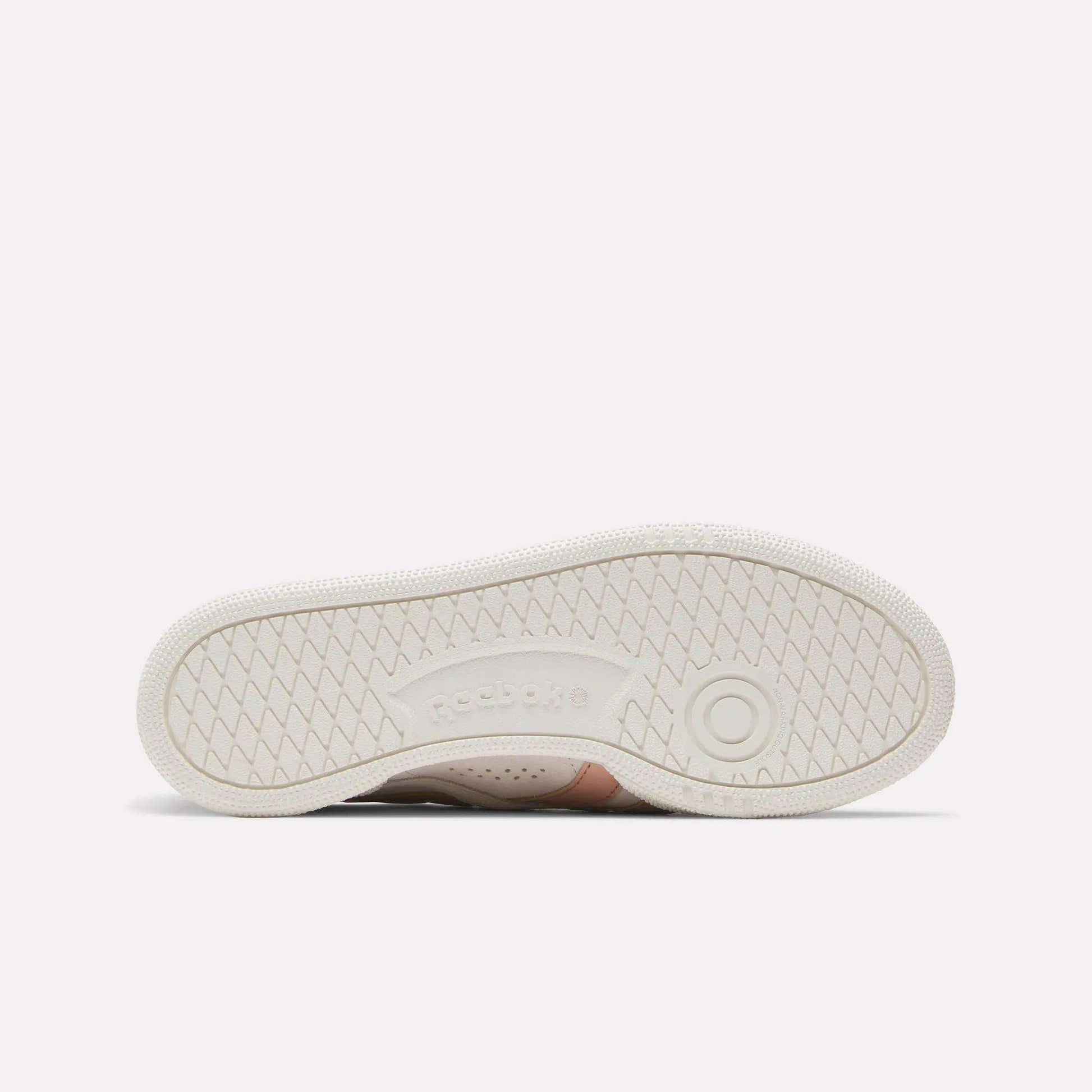 Women's Club C Grounds UK Shoes by Reebok shown with the sole facing up, featuring a textured herringbone tread and embossed Reebok logo—sport-inspired style ideal for casual outfits.