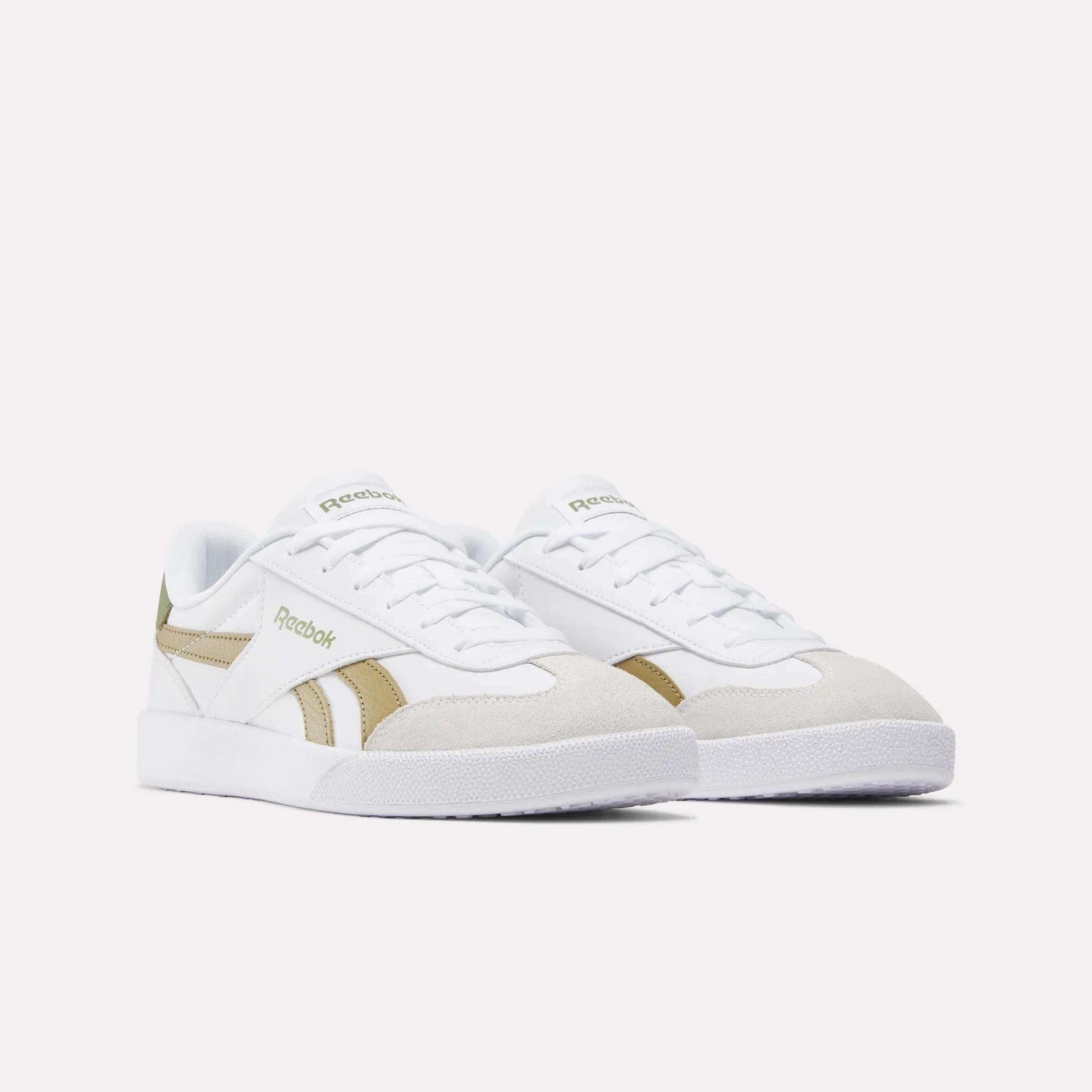 A pair of Reebok Smash Edge Shoes in white, featuring beige suede T-toe accents and gold side detailing, shown on a plain light background.