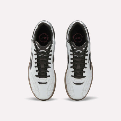 Top view of Reebok Hammer Street Shoes—soccer-inspired full-grain leather shoes with black laces, brown soles, and a pink logo on the black insole—placed side by side on a light background.