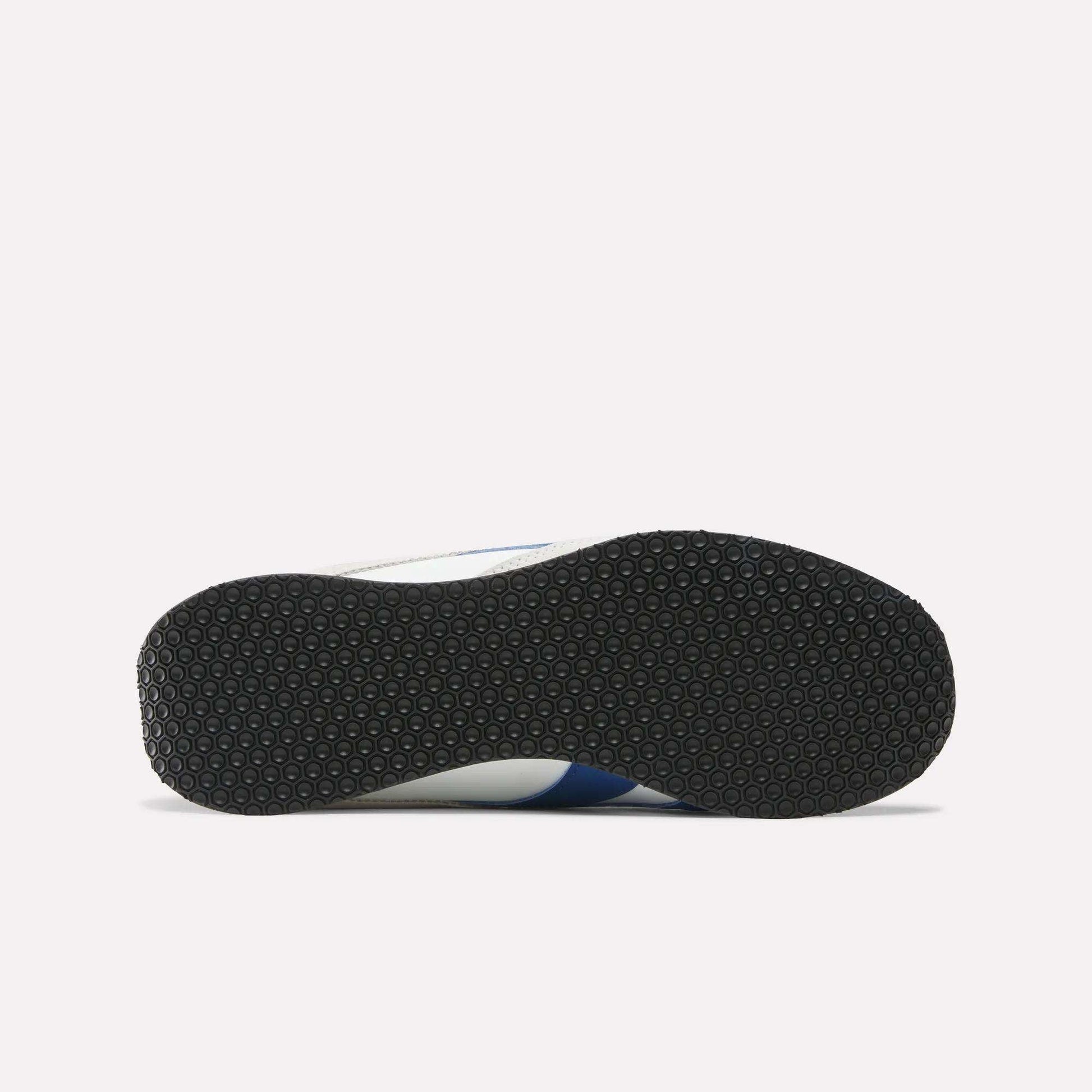 The image displays the bottom view of Reebok R400 Shoes, featuring a black textured rubber sole, set against a plain white background.