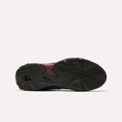 The image displays the bottom view of the Reebok Preseason 94 Low Retro Basketball Shoes, featuring a textured black rubber outsole with a maroon center section and traction grooves—classic elements of '90s Reebok training shoes.