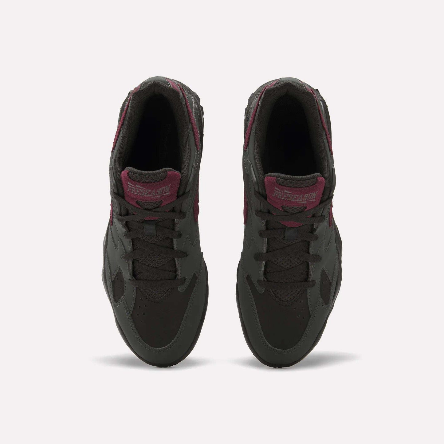 Top view of a pair of Reebok Preseason 94 Low Retro Basketball Shoes in dark gray with maroon accents and laces, placed side by side on a plain white background.