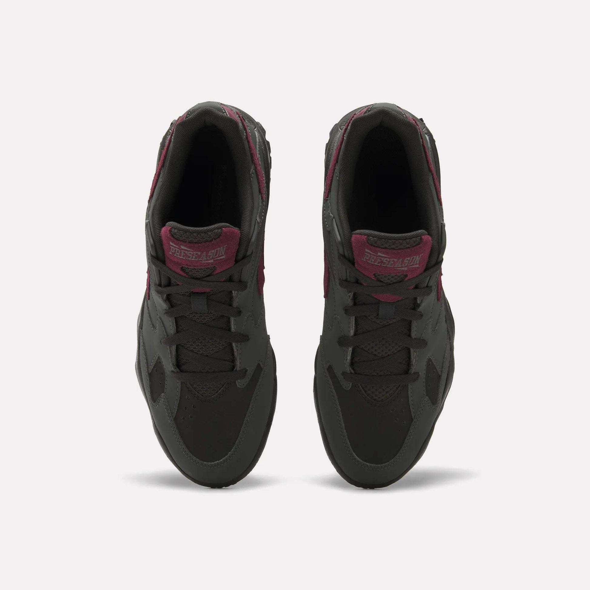 Top view of a pair of Reebok Preseason 94 Low Retro Basketball Shoes in dark gray with maroon accents and laces, placed side by side on a plain white background.