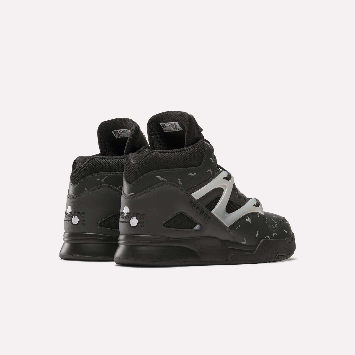A pair of black Reebok Pump Omni Zone II Retro Basketball Shoes, high-top leather design with white side detail and small reflective accents, displayed from the back and side on a plain white background.