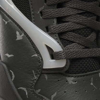 Close-up of the Reebok Pump Omni Zone II Retro Basketball Shoes featuring dark leather, black textured laces, glossy white plastic accents, reflective details, and a light gray bat pattern printed on the leather.
