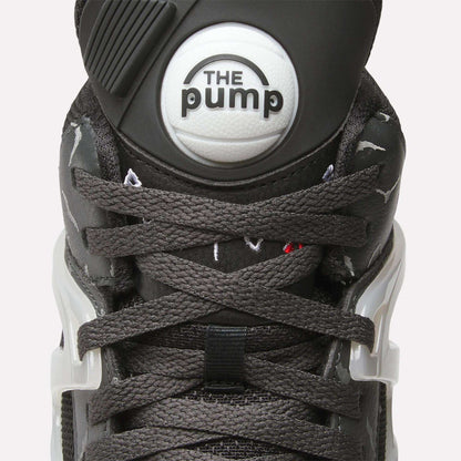 Close-up of Reebok Pump Omni Zone II Retro Basketball Shoes featuring dark gray laces, a round white "The Pump" button on the tongue, white plastic lace holders, and subtle reflective accents on the sides.