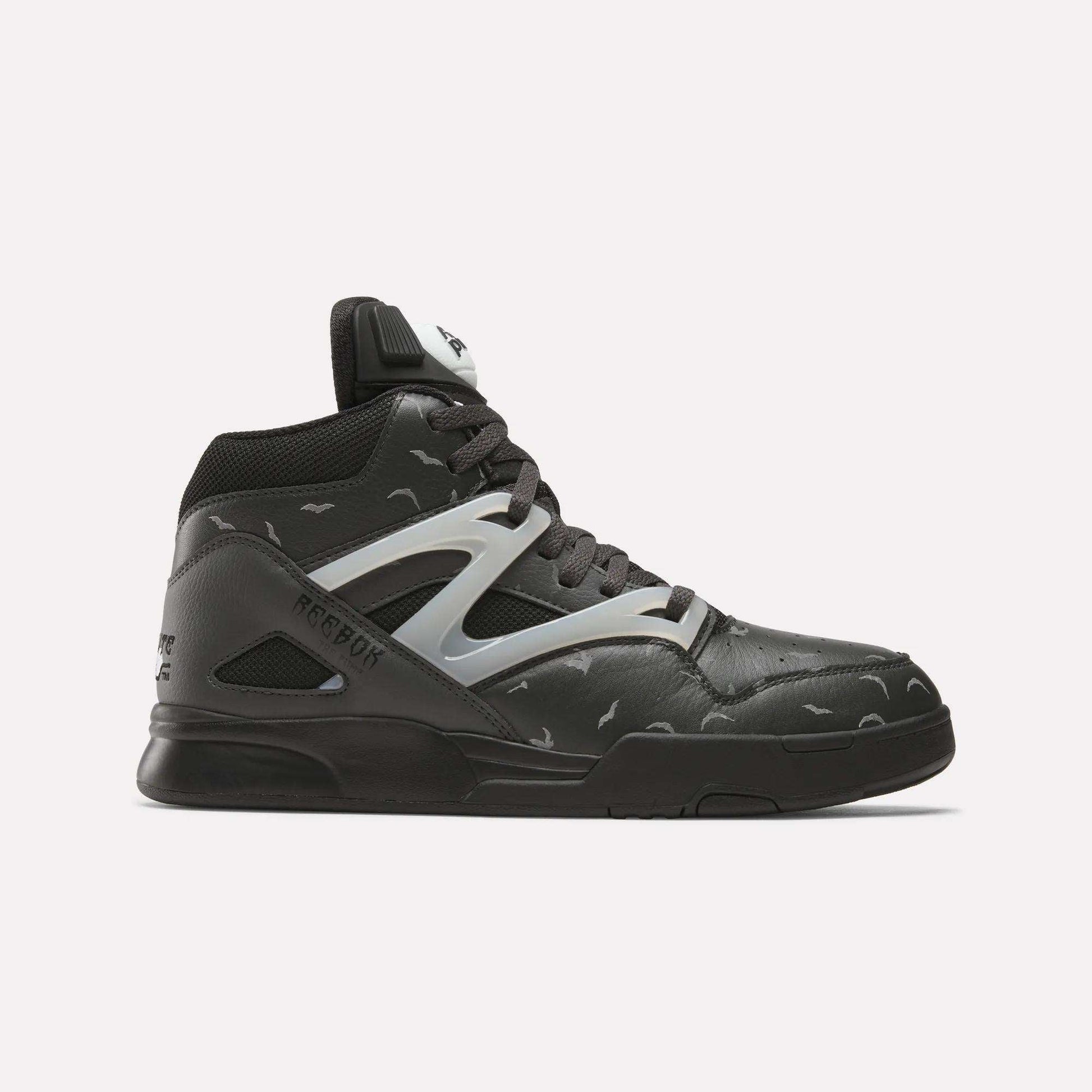 The Reebok Pump Omni Zone II Retro Basketball Shoes feature a black high-top design with gray and reflective accents, a white Reebok logo on the tongue, patterned upper with light gray details, and a black sole.