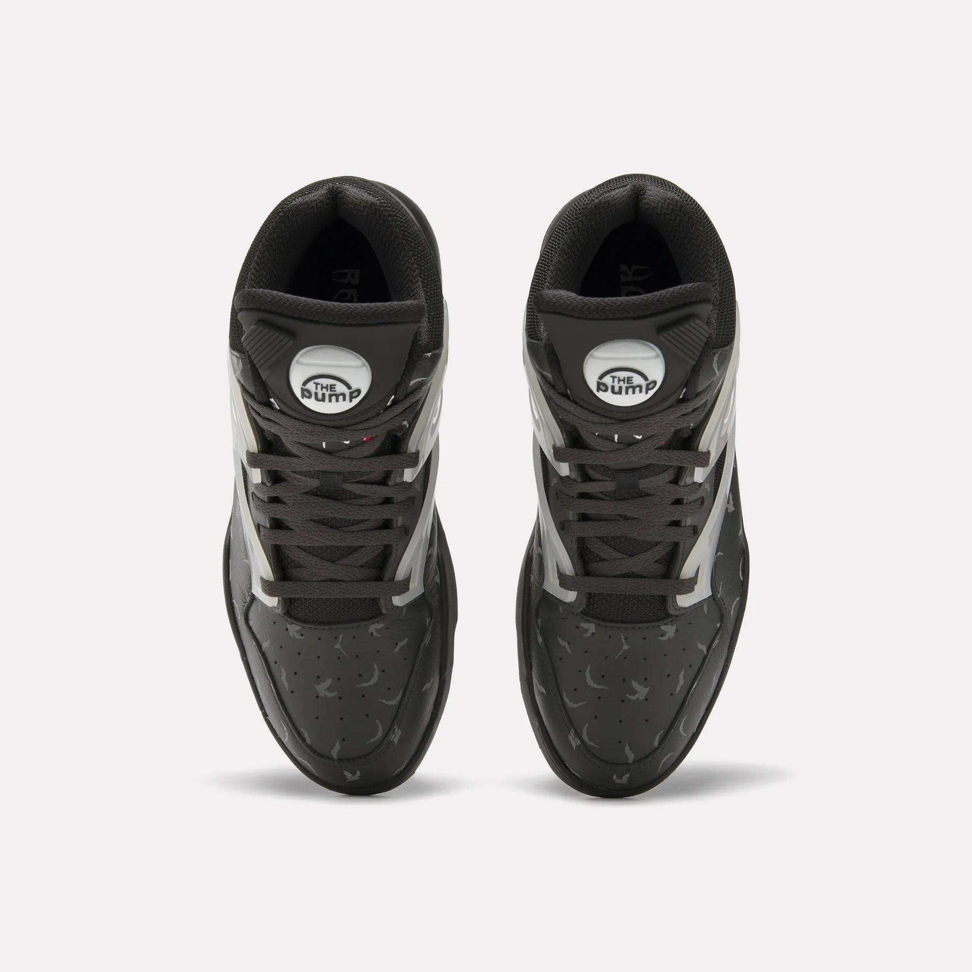 Top view of Reebok Pump Omni Zone II Retro Basketball Shoes with black uppers, white and reflective accents, dark gray laces, and white circular Pump patches on the tongues. The textured surface features small perforations.