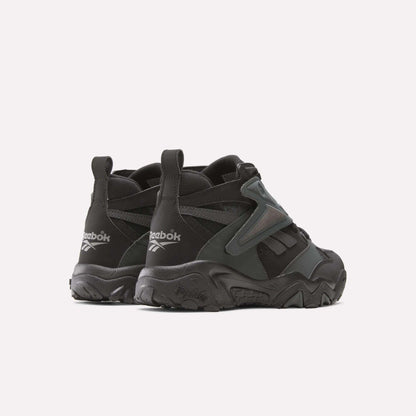 A pair of Reebok Preseason 94 Retro Basketball Shoes is shown from the back and side, featuring chunky soles, textured details, and visible Reebok logos on the heels for a classic '90s vibe.