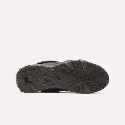 The image shows the black rubber sole of the Reebok Preseason 94 Retro Basketball Shoes, viewed from underneath, displaying textured patterns and grooves designed for traction.