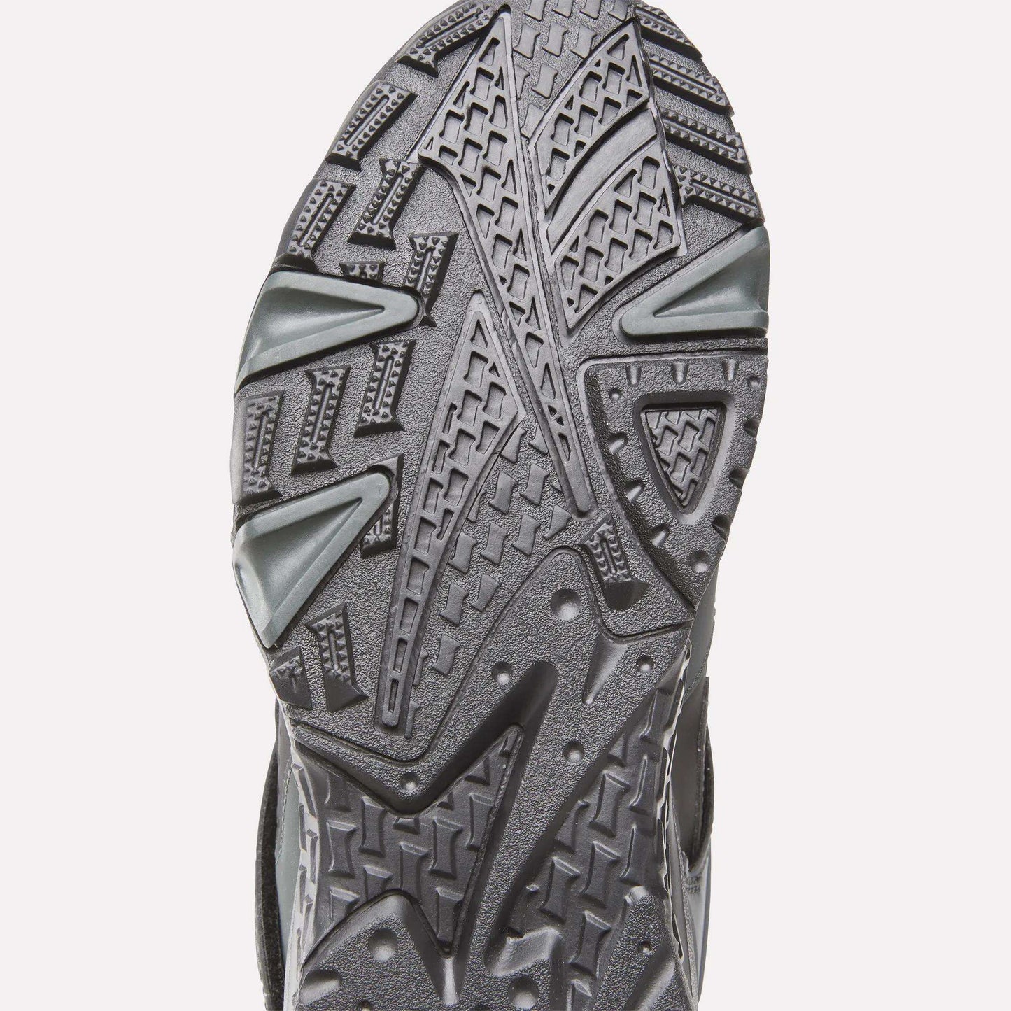 Close-up of the sole on Reebok Preseason 94 Retro Basketball Shoes, highlighting its detailed, textured tread pattern with geometric shapes and grooves designed for traction.