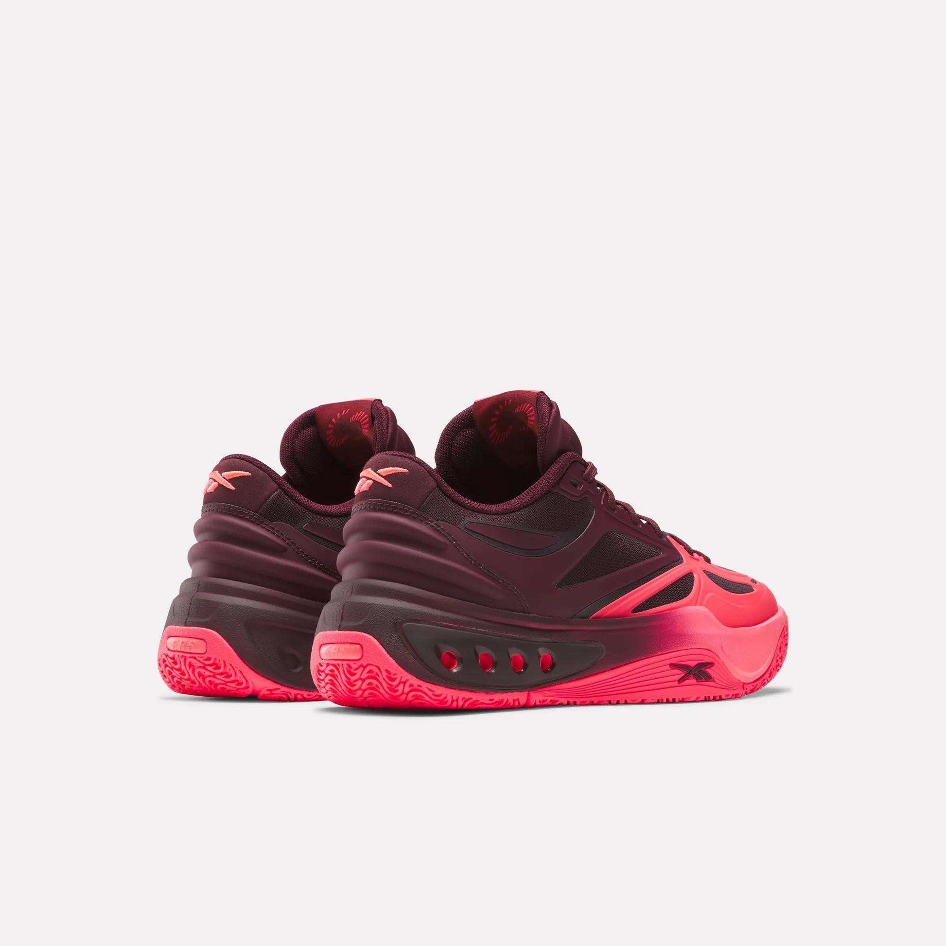 Engine A Basketball Shoes by Reebok in bright pink and dark maroon, with gradient soles and SuperFloat foam, are shown from the back and side on a plain white background.