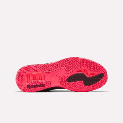 The image shows the vibrant pink outsole of the Reebok Engine A Basketball Shoes, featuring wavy tread patterns, black accents, SuperFloat foam for comfort, and a Reebok logo near the heel.