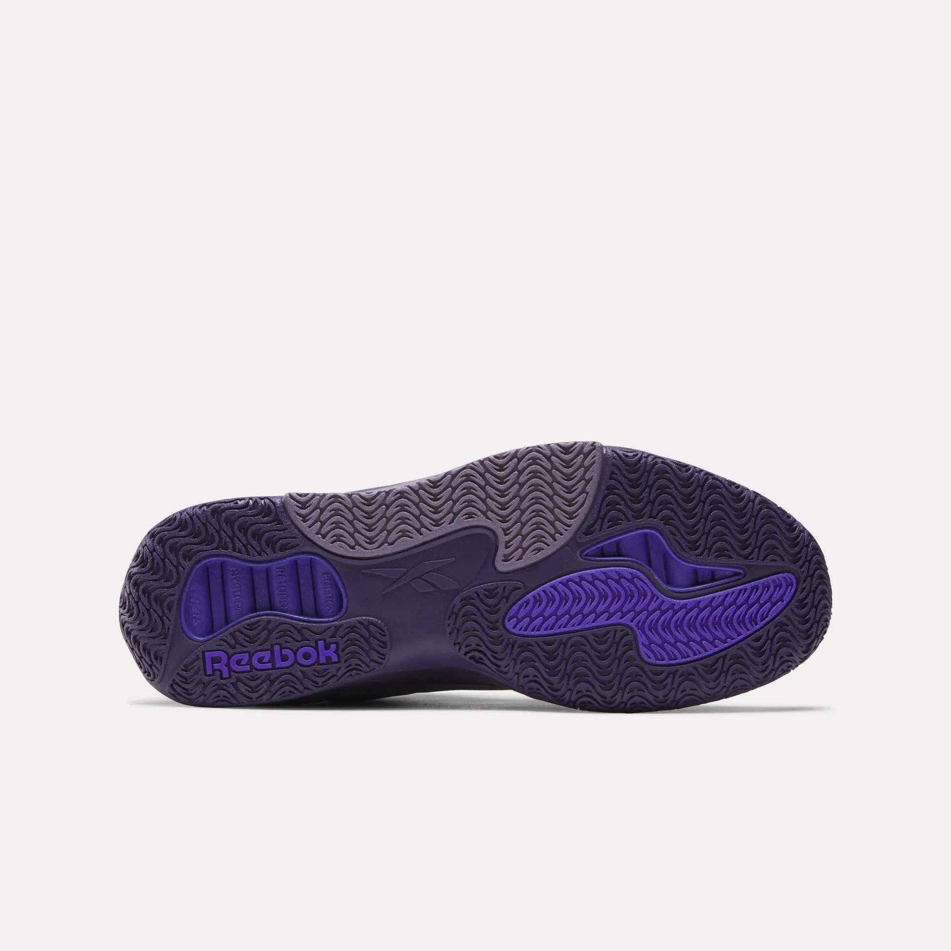 The image shows the purple outsole of Reebok Engine A Basketball Shoes with wavy textured patterns and the Reebok logo near the heel, designed for performance and featuring SuperFloat foam for optimal comfort.