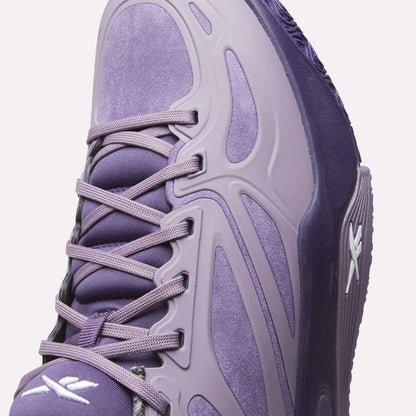 Close-up of the Reebok Engine A Basketball Shoes in purple suede with synthetic overlays, purple laces, and white Reebok logos. Modern curved lines and ERS technology deliver comfort and style inspired by performance basketball shoes.