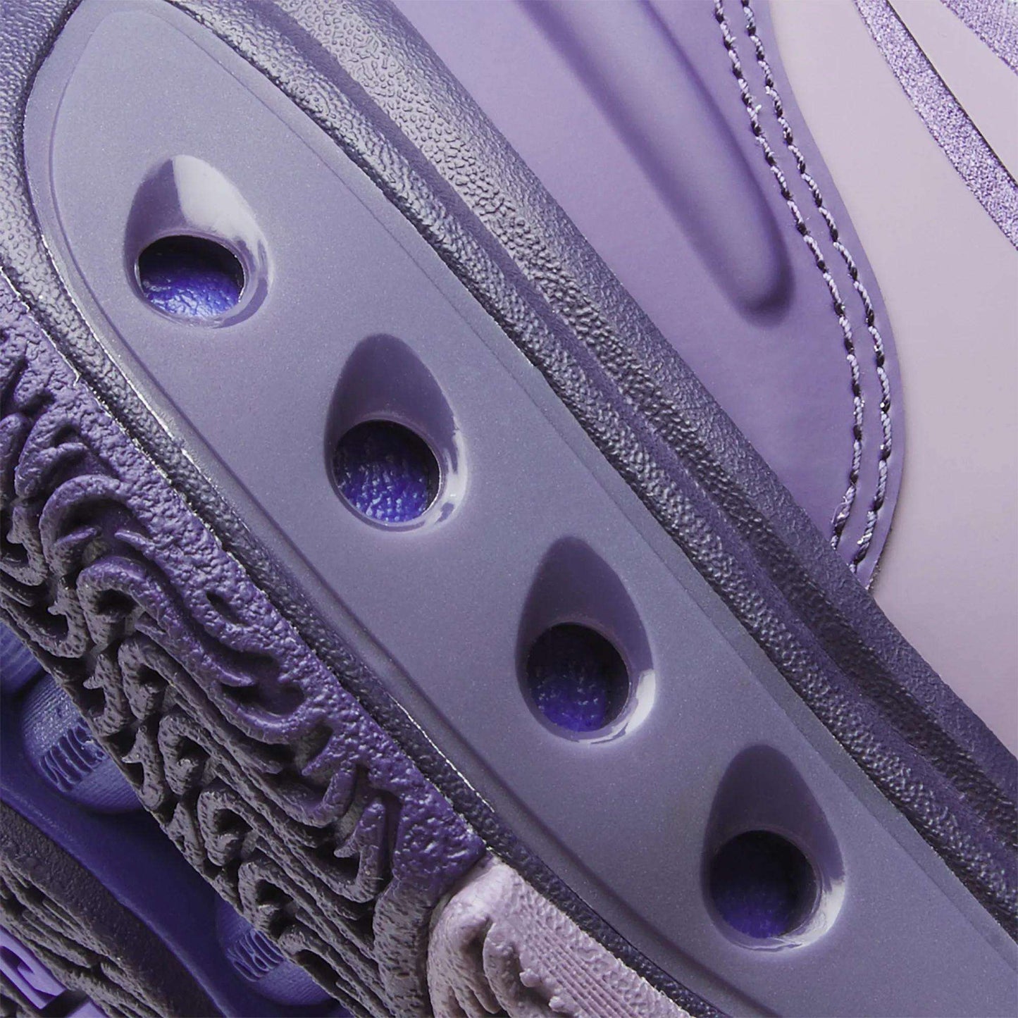 Close-up of Reebok Engine A Basketball Shoes in purple/lavender, showcasing textured and smooth surfaces, detailed stitching, three oval ventilation holes, and advanced SuperFloat foam for superior comfort.