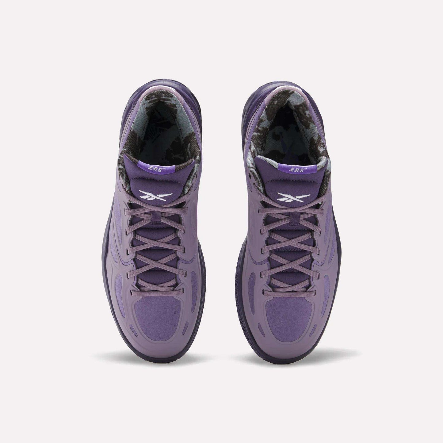 Top view of Reebok Engine A Basketball Shoes in purple with black and white patterned inner lining, white Reebok logos on the tongues, and advanced ERS technology, set against a plain white background.
