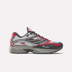 The Reebok Premier Road Control Shoes are shown in a side profile on a plain white background, featuring red, white, and gray colors with black accents, mesh panels, and the signature Reebok logo on the side.