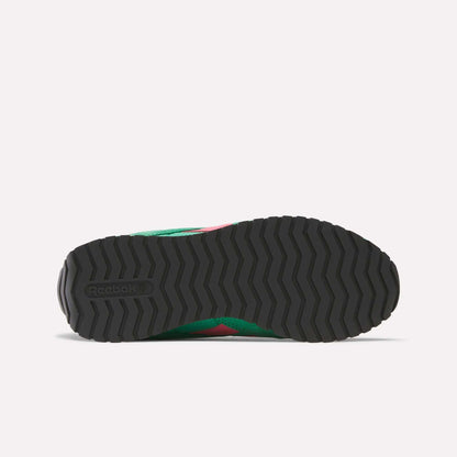 Bottom view of Reebok Women's Classic AZ Shoes featuring a black rubber outsole with a zigzag tread and Reebok logo. The green and pink midsole and upper of this retro running shoe are partially visible.