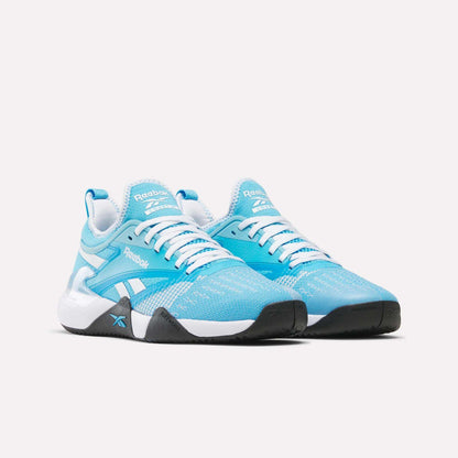 A pair of Reebok Nano Court Shoes in light blue and white with black soles for multidirectional traction, white laces, and Reebok logos on the sides and tongues, displayed on a plain white background.
