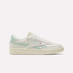 The Reebok Women's Club C Revenge Vintage Shoes are shown in cream with light green accents, displaying the Reebok logo and British flag in a side profile against a white background, echoing classic vintage style.