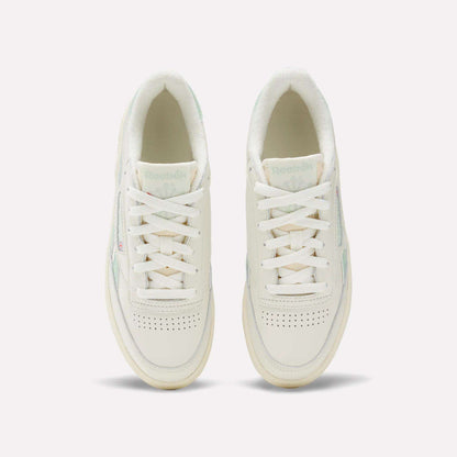 A pair of Women's Club C Revenge Vintage Shoes by Reebok in white with light green accents, shown from above. Features include white laces, perforated toe boxes, and the visible Reebok logo on the tongues.
