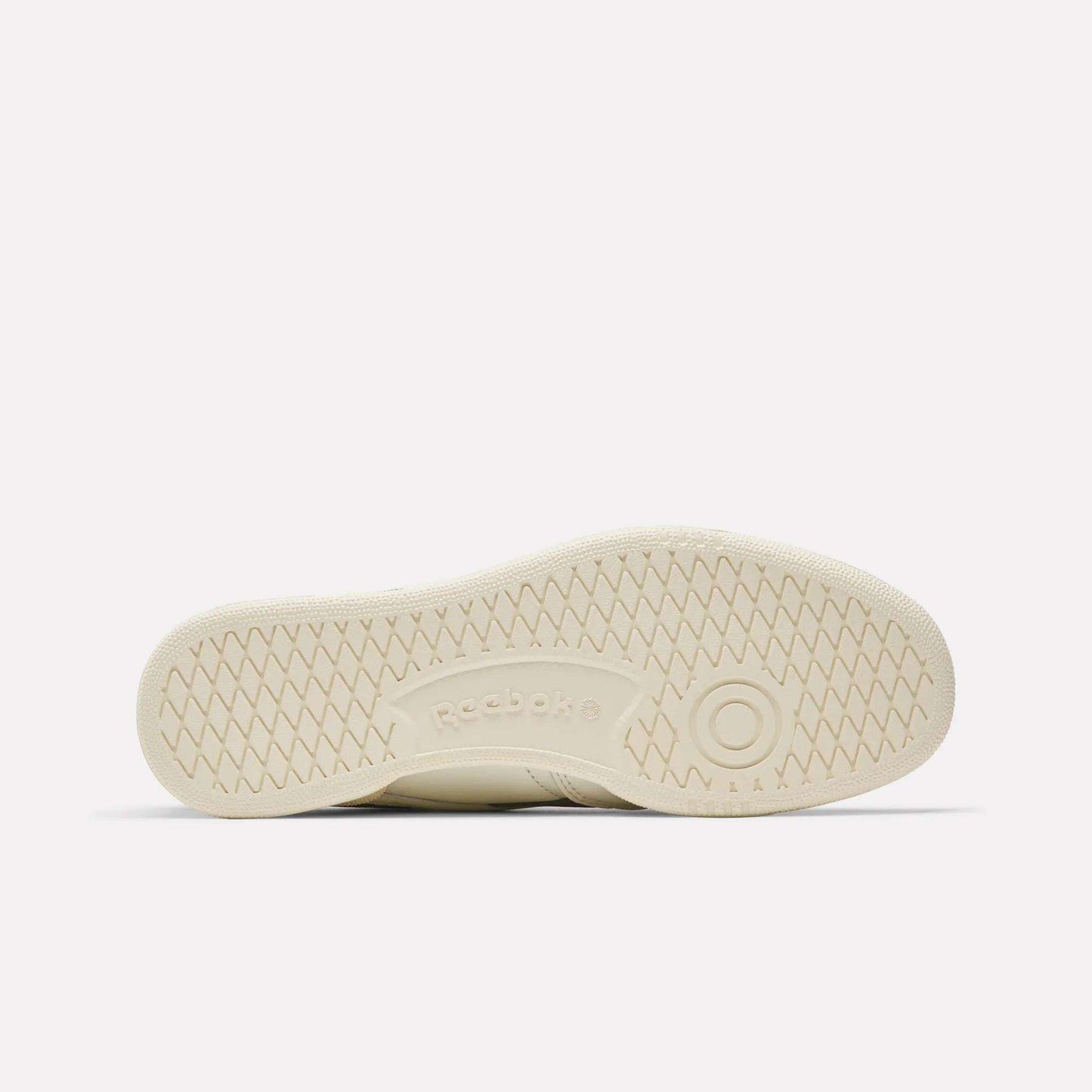 The image shows the beige sole of Reebok Club C Revenge Vintage Shoes, flat against a white background, featuring a textured grip pattern and the Reebok logo embossed at the center for a classic vintage look.