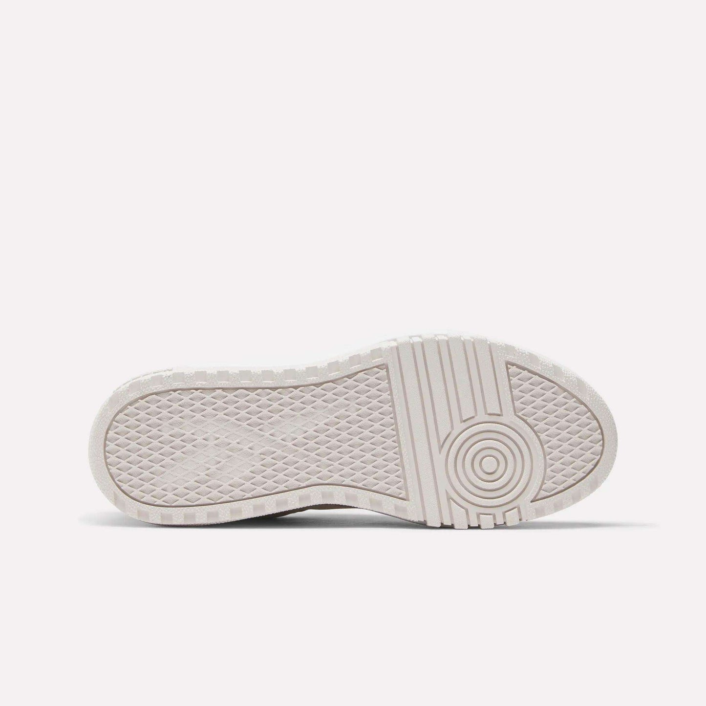 The image displays the bottom view of the Reebok Women's Campio Extra Shoes, highlighting a white platform sole with a textured tread featuring diamond shapes on the left and circular patterns on the right for enhanced grip and traction.