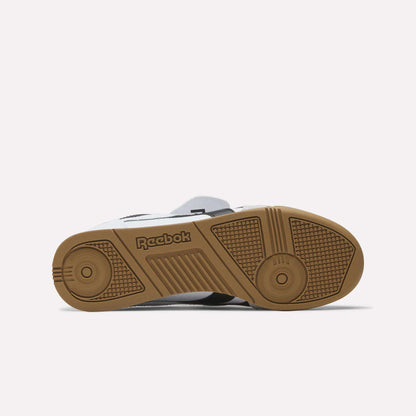 The image displays the sole of the Reebok Campio XT Kilty Shoes, showing a brown rubber outsole with grip-enhancing textures and the Reebok logo, all inspired by tennis style. The shoe is sole-up against a plain white background.
