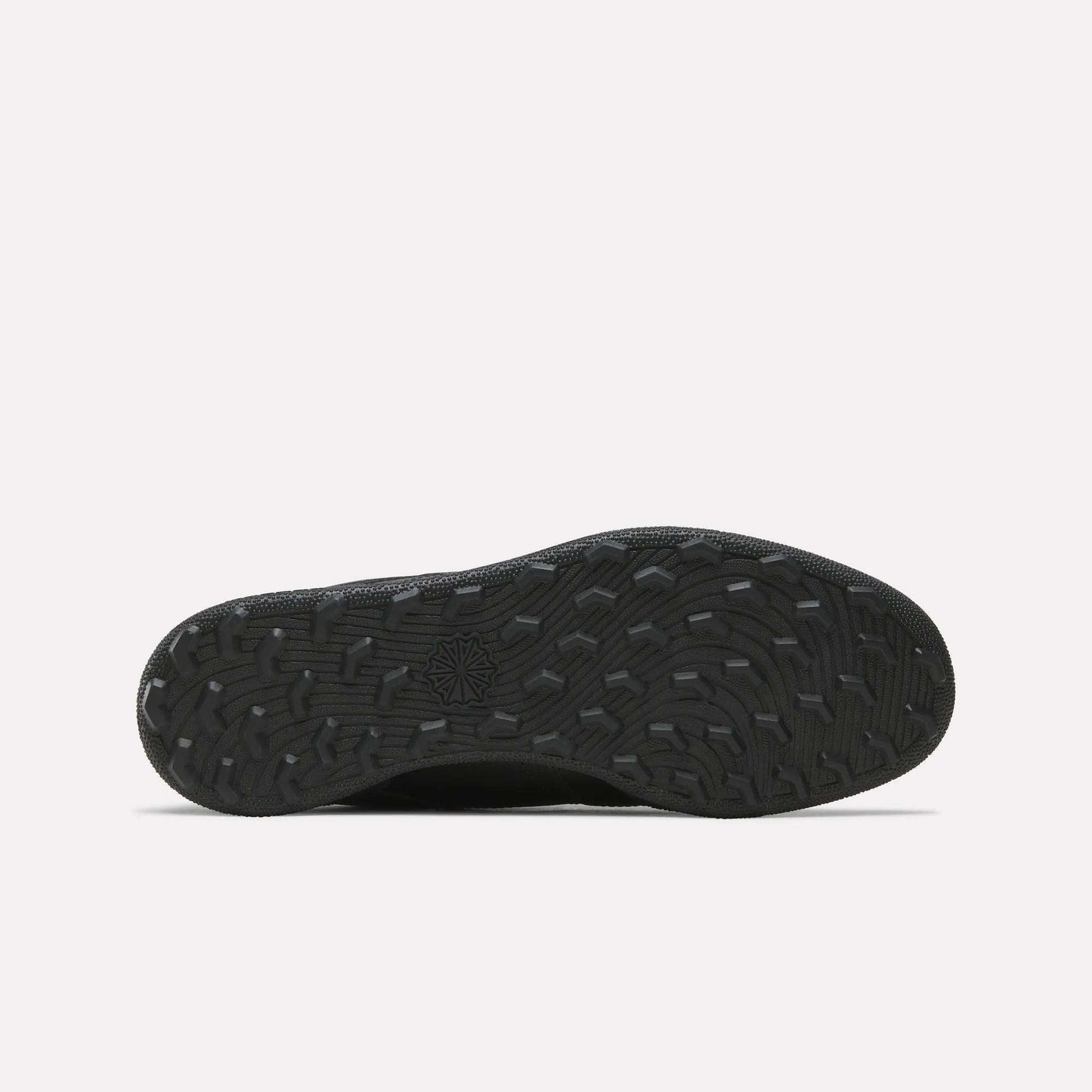 The Reebok Men's Club C Golf Shoes feature a black rubber spikeless outsole with textured, wavy treads and a central star design, ideal for golf, displayed on a plain white background.