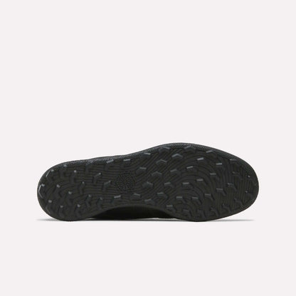 The Reebok Men's Club C Golf Shoes feature a black rubber spikeless outsole with textured, wavy treads and a central star design, ideal for golf, displayed on a plain white background.