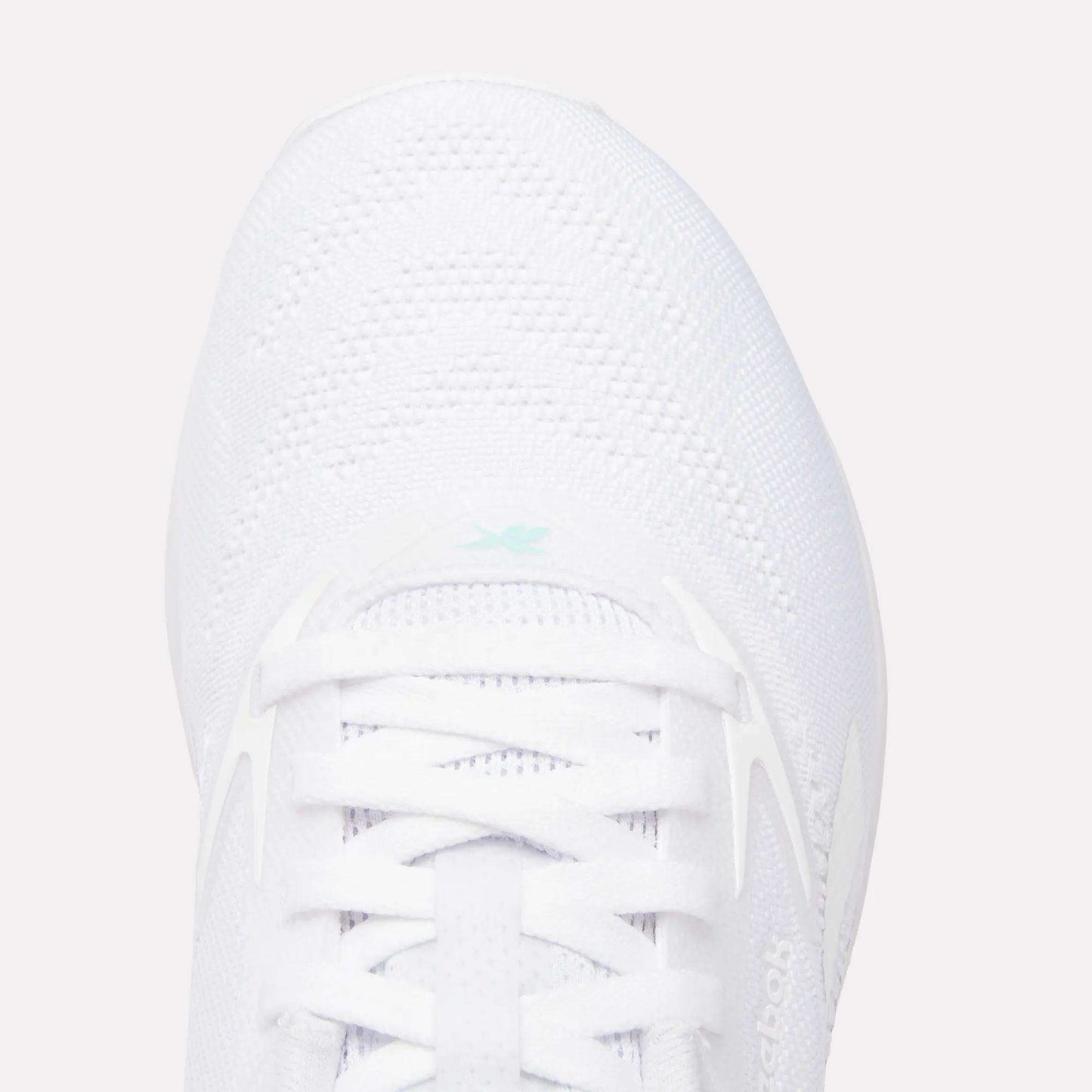 Top view of the Women's Nano X5 Training Shoes by Reebok, featuring comfortable white laces, breathable mesh texture, and a small light blue Reebok logo near the tongue.