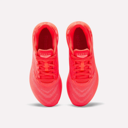 Top view of a pair of vibrant red Reebok Women's Nano X5 Training Shoes with knit uppers, placed side by side on a white background. The insoles display the brand and model, emphasizing these stylish women’s trainers.