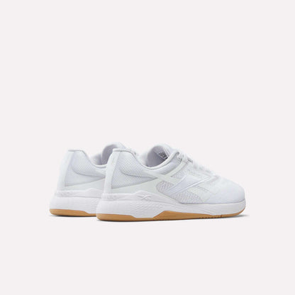 The Reebok Women's Nano X5 Training Shoes are white athletic sneakers with mesh uppers, white laces, and light brown rubber soles. Displayed against a plain background, both the heel and side views highlight their comfortable design.