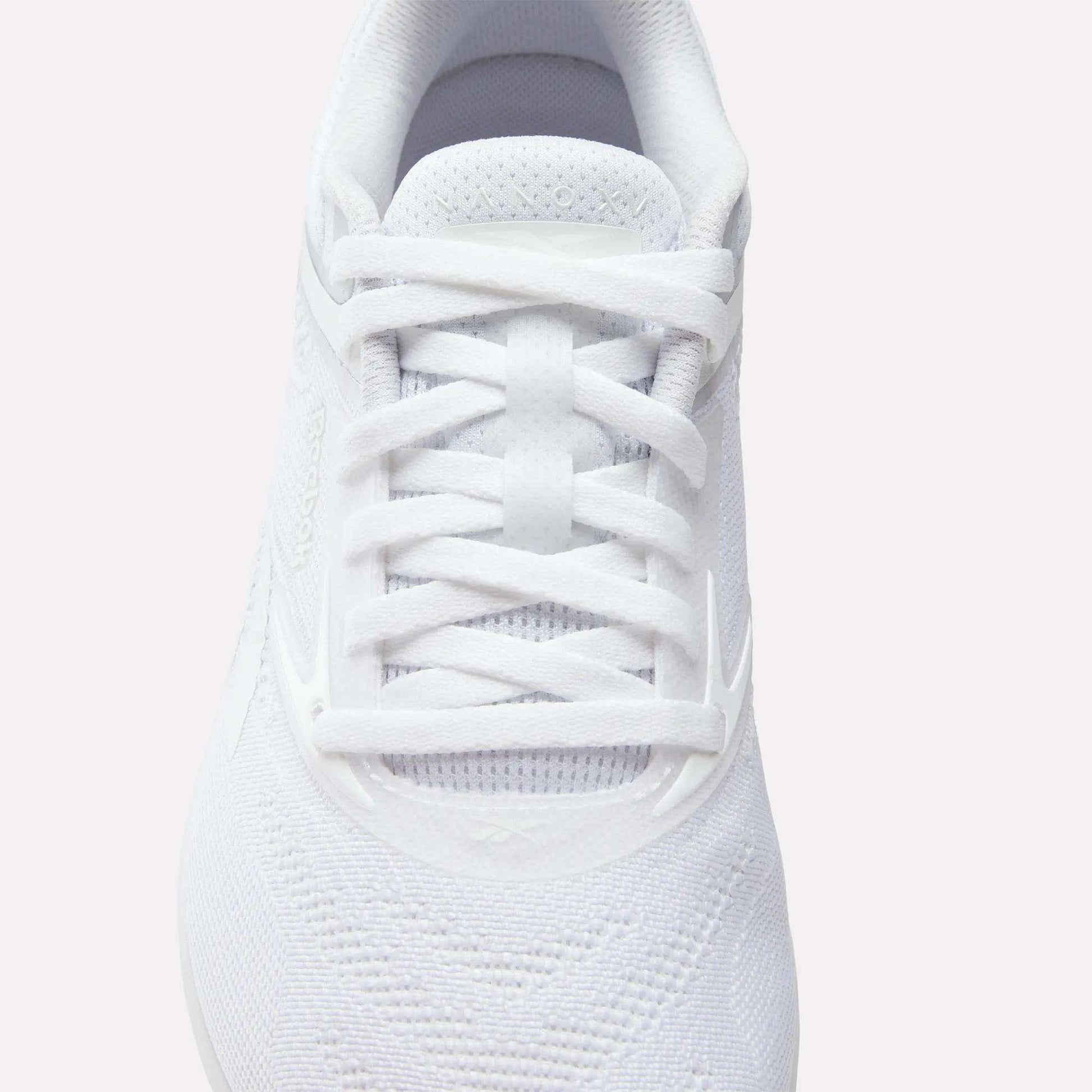 A close-up, top-down view of the Reebok Women's Nano X5 Training Shoes in white, featuring white laces, breathable mesh fabric, and subtle stitched patterns—an essential for any iconic training shoe collection.