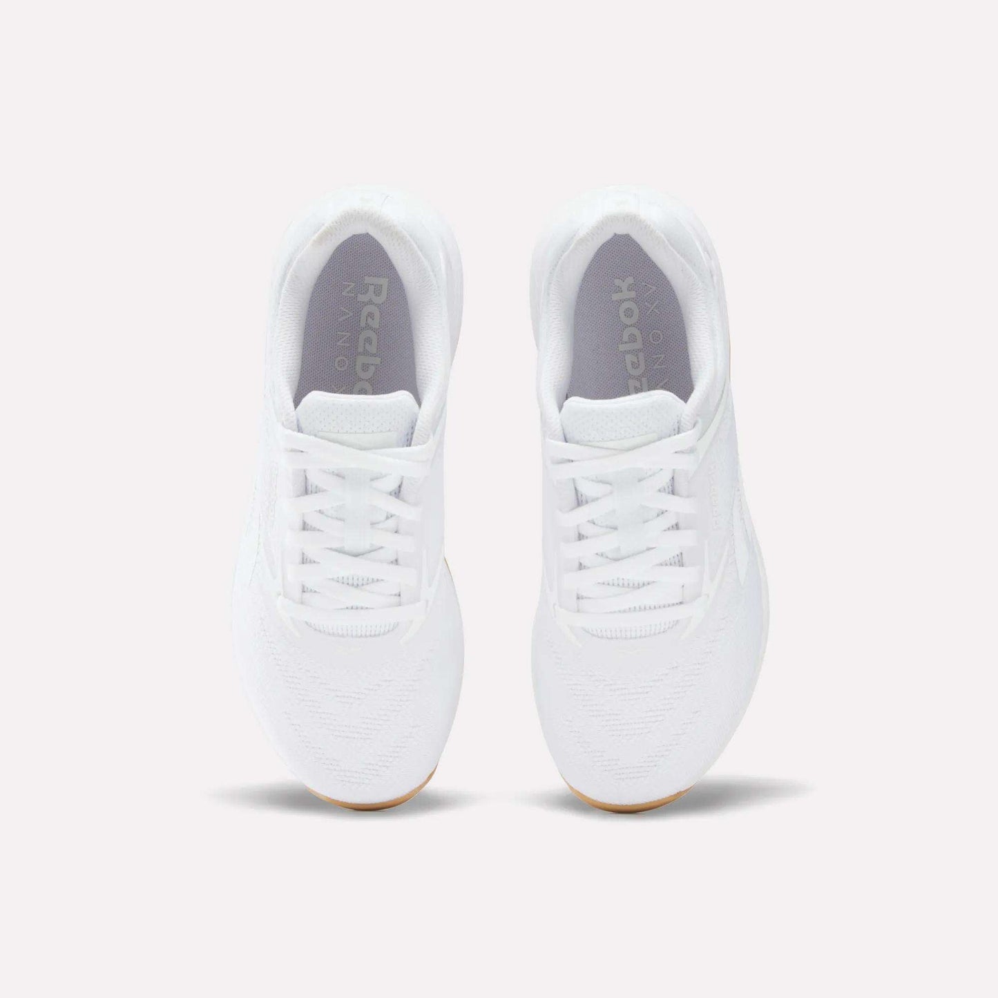 A pair of Women's Nano X5 Training Shoes by Reebok, shown from above with visible laces, toe area, and logo on the insoles, displayed against a plain light background.