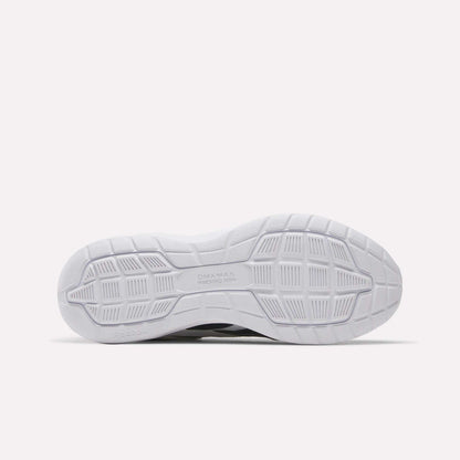 The image shows the white outsole of the Reebok Men's Walk Ultra 7 DMX Max Wide 4E Shoes, featuring a textured geometric tread with grooves, squares, and rectangles for grip. The DMX MAX branding appears near the center.