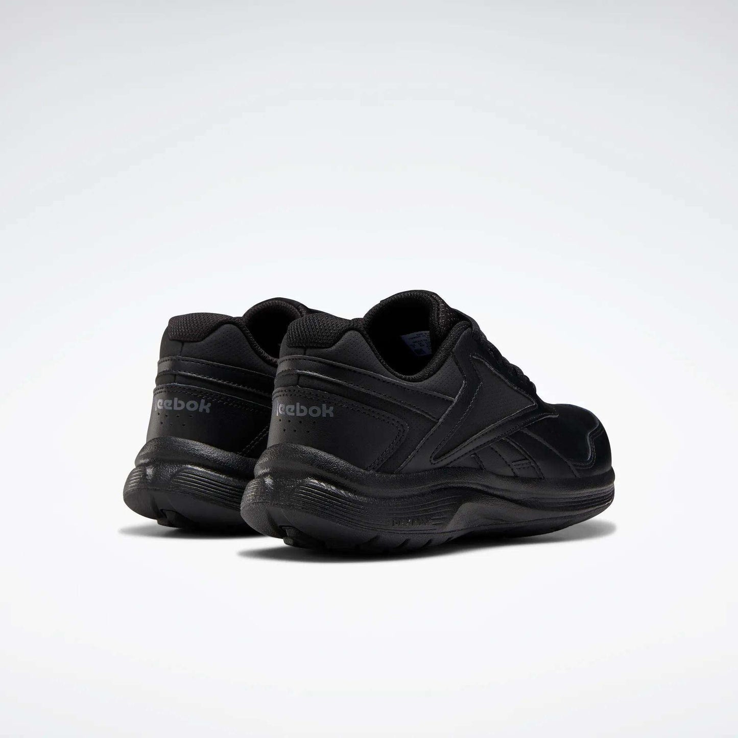 The image shows Reebok Women's Walk Ultra 7 DMX Max Walking Shoes in black on a white background, angled to display the back and sides, emphasizing their DMX cushioning for superior comfort.