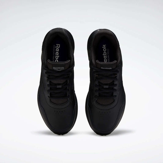 A pair of Women's Walk Ultra 7 DMX Max Walking Shoes by Reebok, shown from above with black laces and a minimalist design featuring DMX cushioning for comfort, set against a plain white background.