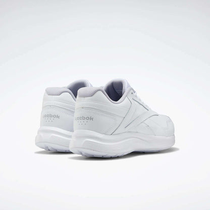 The Reebok Women's Walk Ultra 7 DMX Max Walking Shoes are displayed all in white on a light background, with one shoe slightly ahead to show both the side and back views. These walking shoes offer DMX cushioning for all-day comfort.