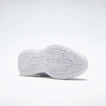 The image shows the sole of a Reebok Women's Walk Ultra 7 DMX Max Walking Shoe. Its white, textured grip and DMX cushioning enhance comfort. The shoe is positioned on its side against a plain, light background.