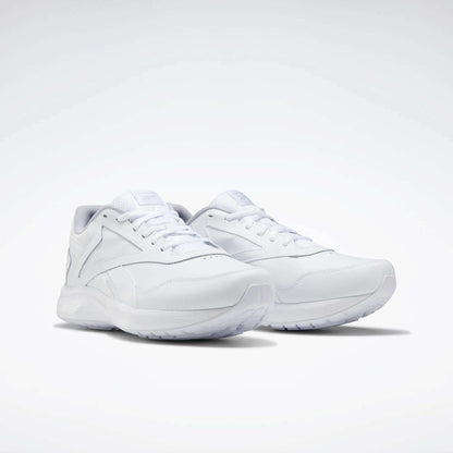 The Reebok Women's Walk Ultra 7 DMX Max Walking Shoes are shown in white on a light background, featuring a sleek minimalist design, white laces, DMX cushioned textured sole, and subtle stitched detailing.