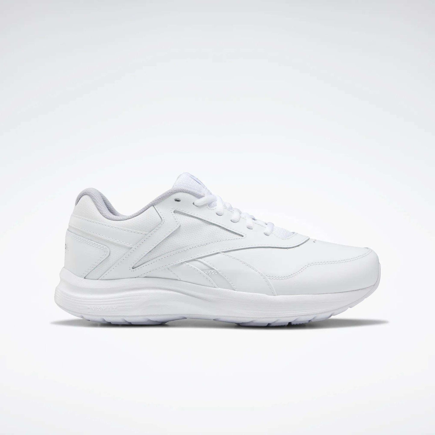 The Women's Walk Ultra 7 DMX Max Walking Shoes by Reebok, shown in side profile with sleek white design and subtle stitching against a plain background, feature DMX cushioning for all-day walking comfort.