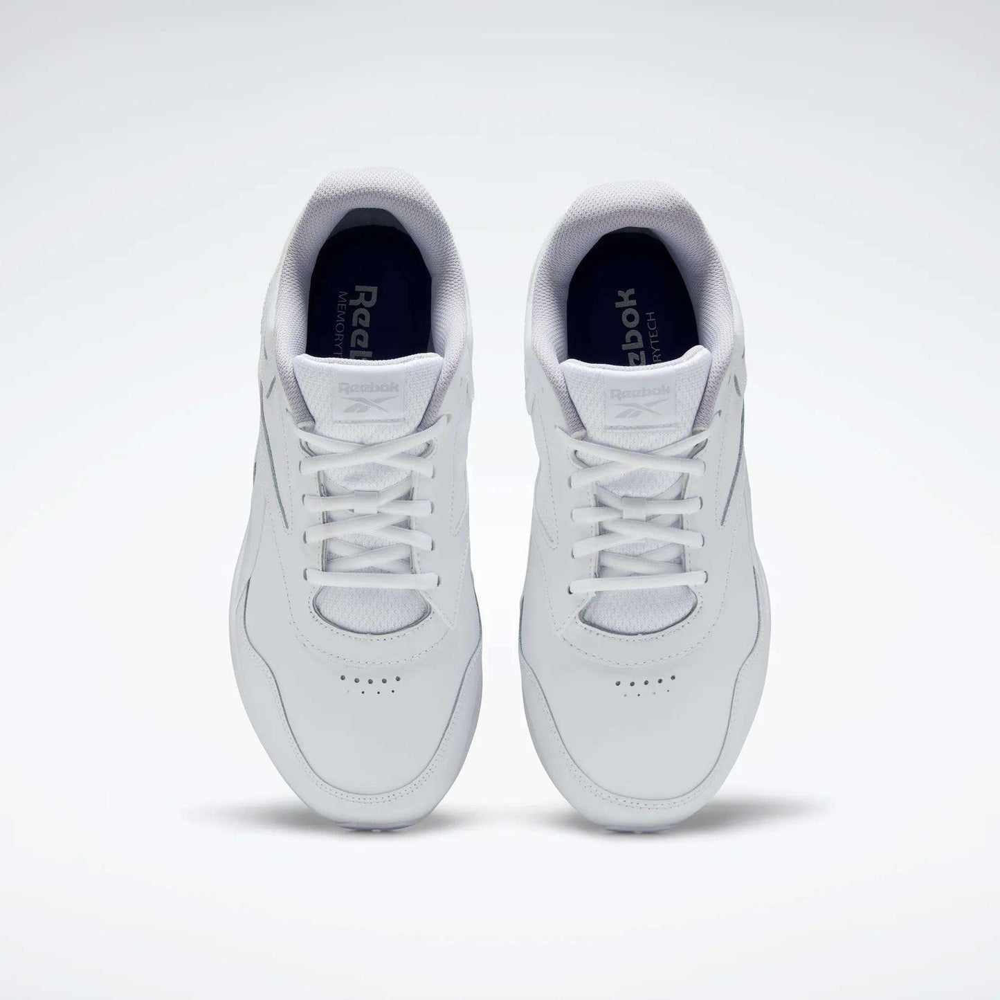 A pair of Reebok Women's Walk Ultra 7 DMX Max Walking Shoes in white, shown from above with visible tops and laces on a plain light background, featuring DMX cushioning for all-day comfort.