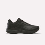 The Reebok Walk Ultra 7 DMX Max Walking Shoes are black, low-top sneakers with lace-up closure and a textured sole featuring DMX cushioning, shown in side profile on a plain white background.