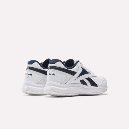 The Reebok Walk Ultra 7 DMX Max Walking Shoes in white with navy blue logo and trim accents, feature breathable mesh panels and are shown from the back and side on a plain white background.