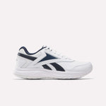 The Reebok Walk Ultra 7 DMX Max Walking Shoe in white with navy blue accents and the signature logo on the side features breathable mesh and cushioned support, shown from the left against a plain white background.